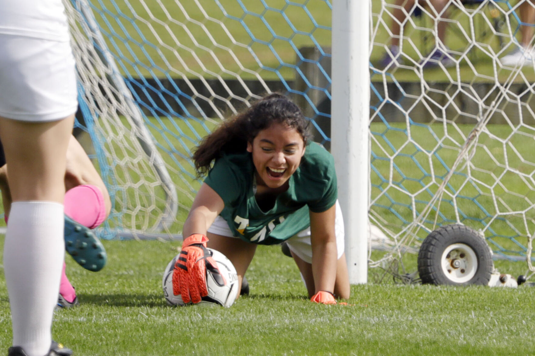 Maria Gonzalez dives for soccer ball
